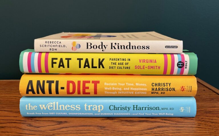 Four books stacked horizontally, Body Kindness, Fat Talk, Anti-Diet and the Wellness Trap