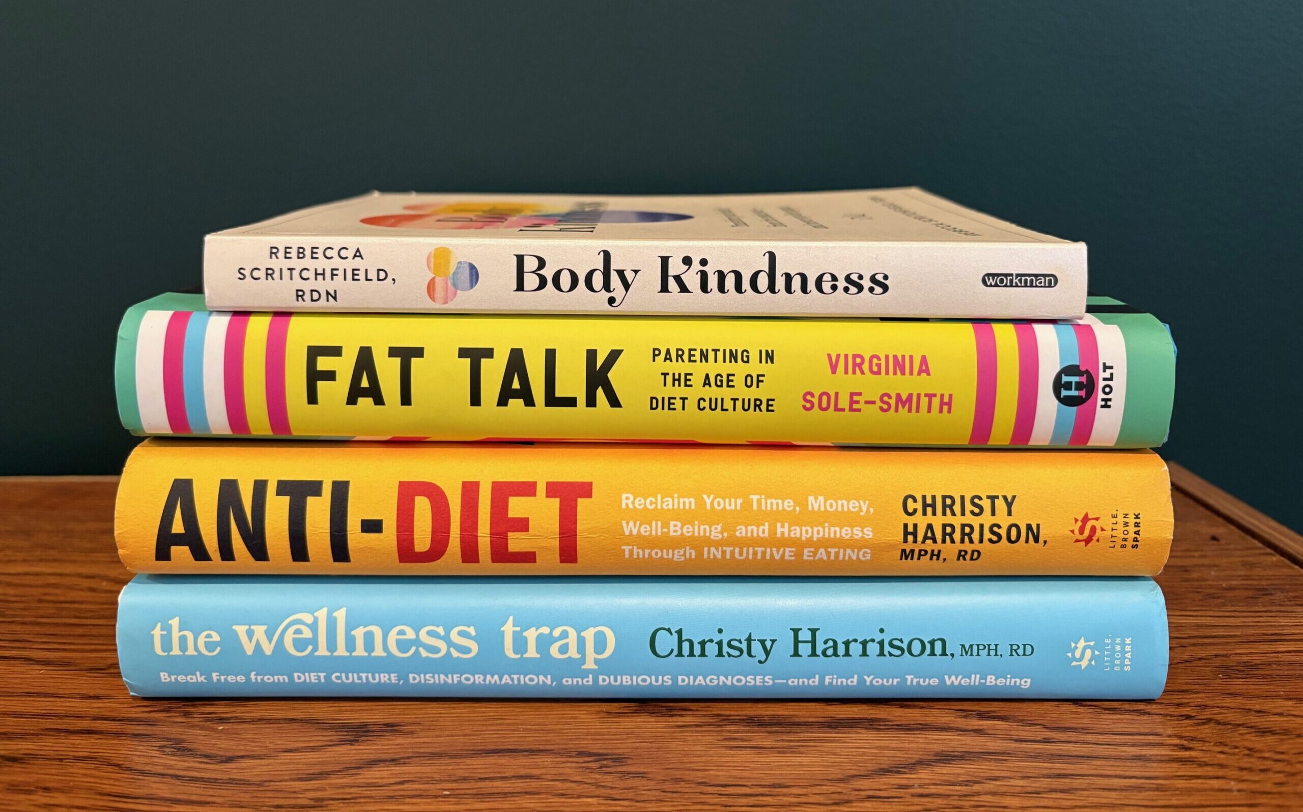 Four books stacked horizontally, Body Kindness, Fat Talk, Anti-Diet and the Wellness Trap