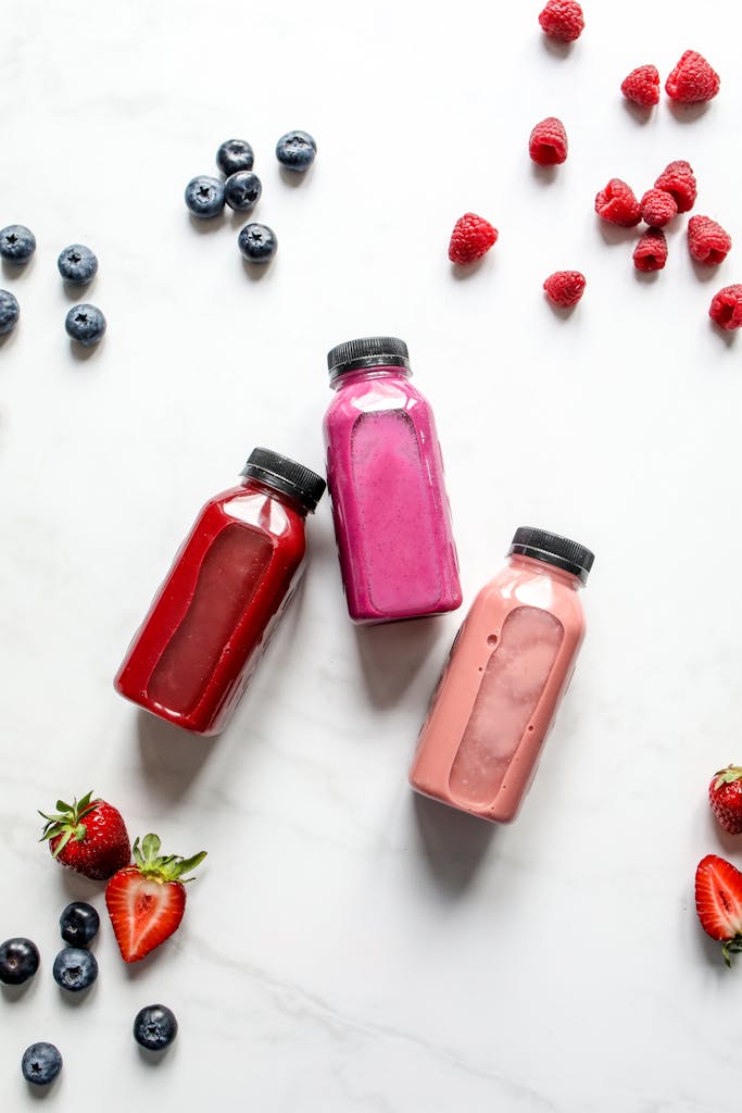 Overhead view of vibrant berry smoothies in bottles. Smoothies can be an easy way to get nutrition when you have a low appetite.